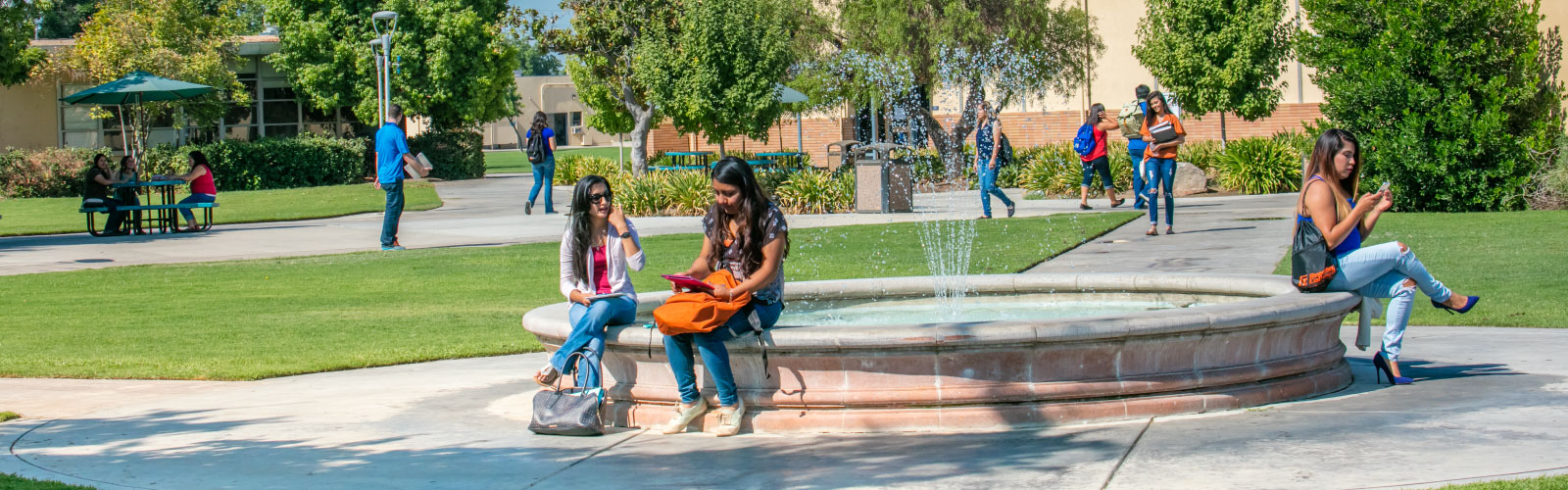 Students sitting around the fountain