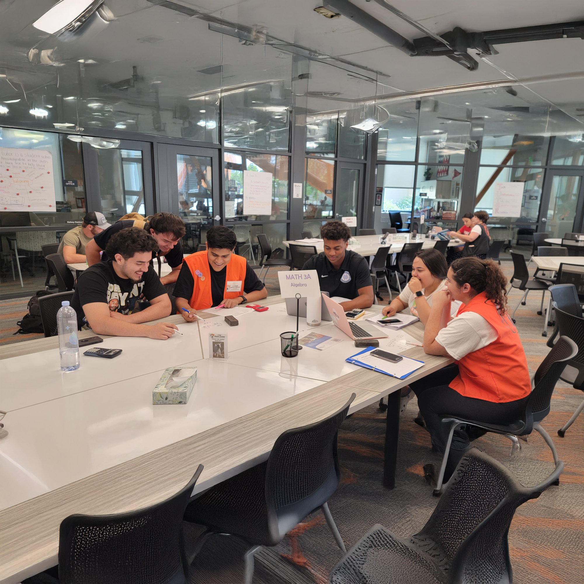 group of students in the tutoring center in a table discussing