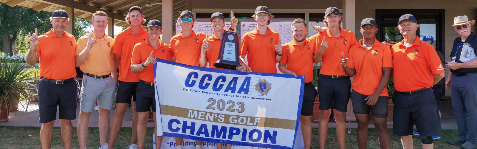 Men's Golf Team holding state championship banner
