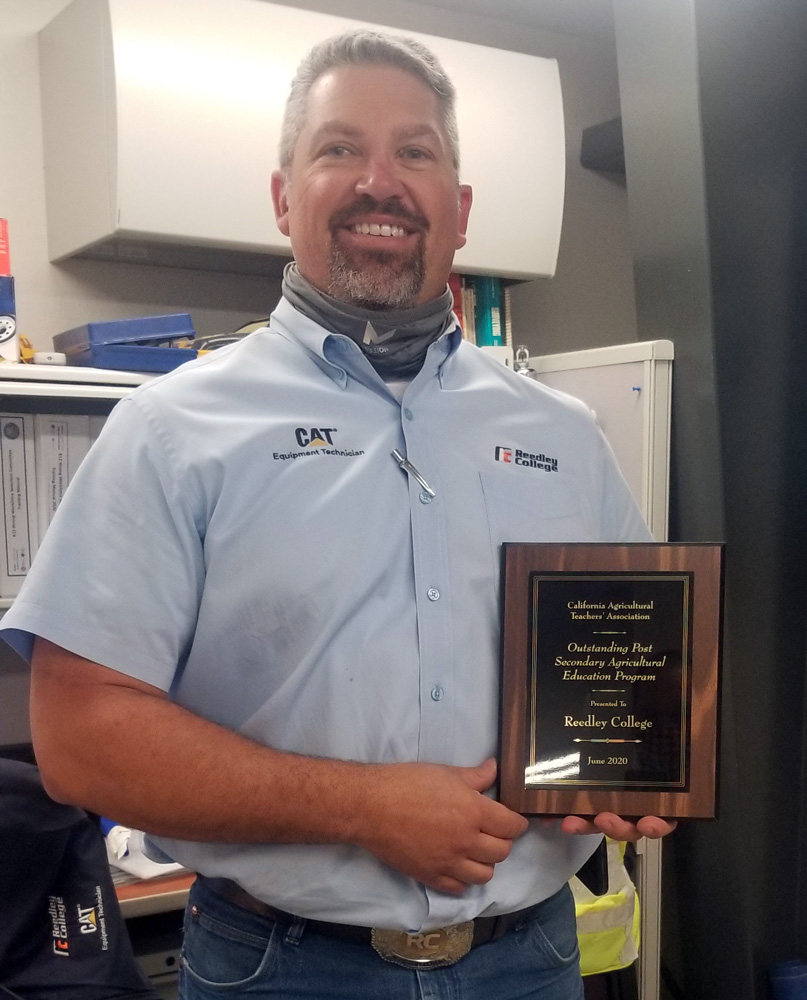 Instructor Nick Defteros holding Plaque