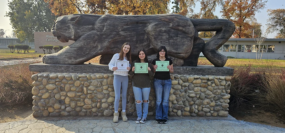Three honors students with awards