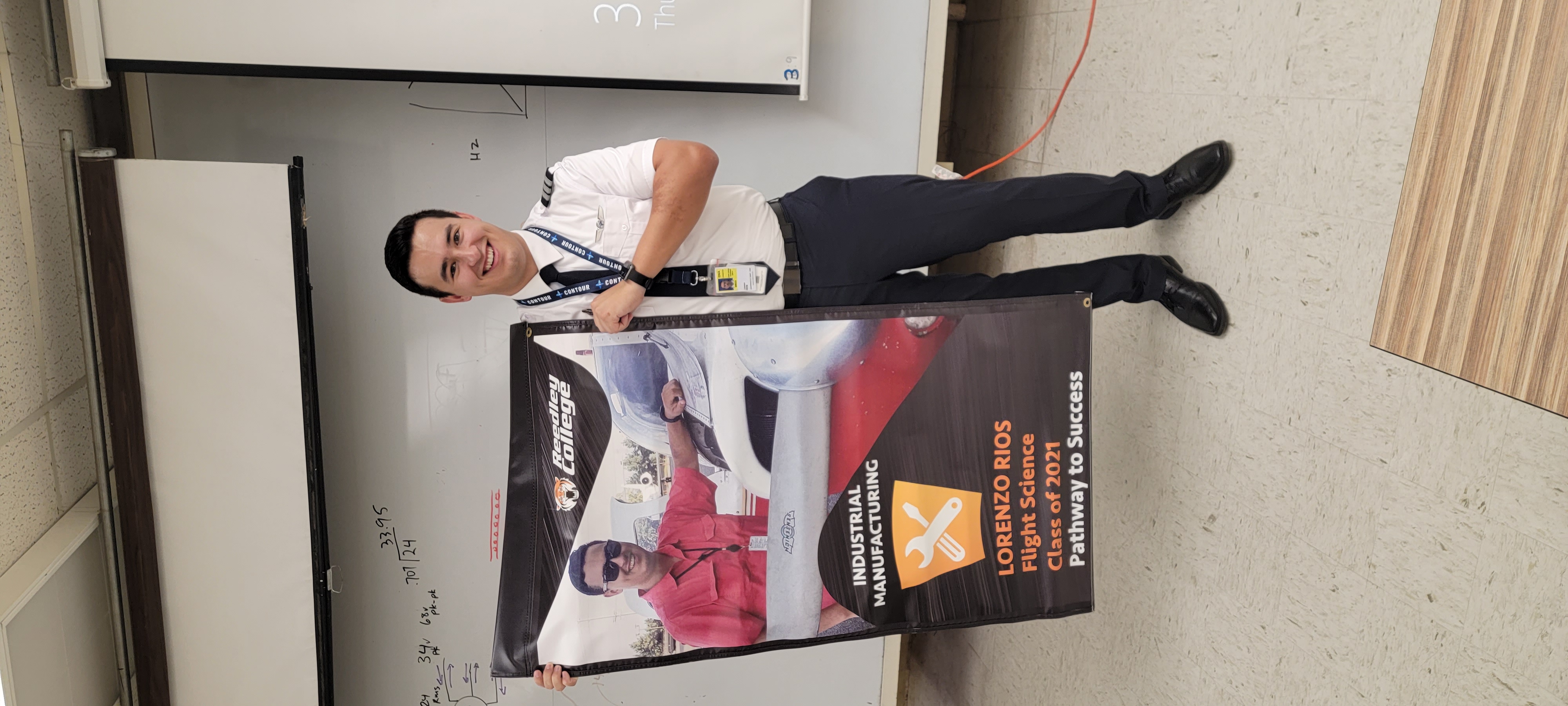 Lorenzo Rios with his student pathway banner