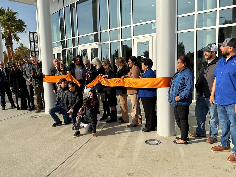 McClarty Cutting ribbon in front of CFPA
