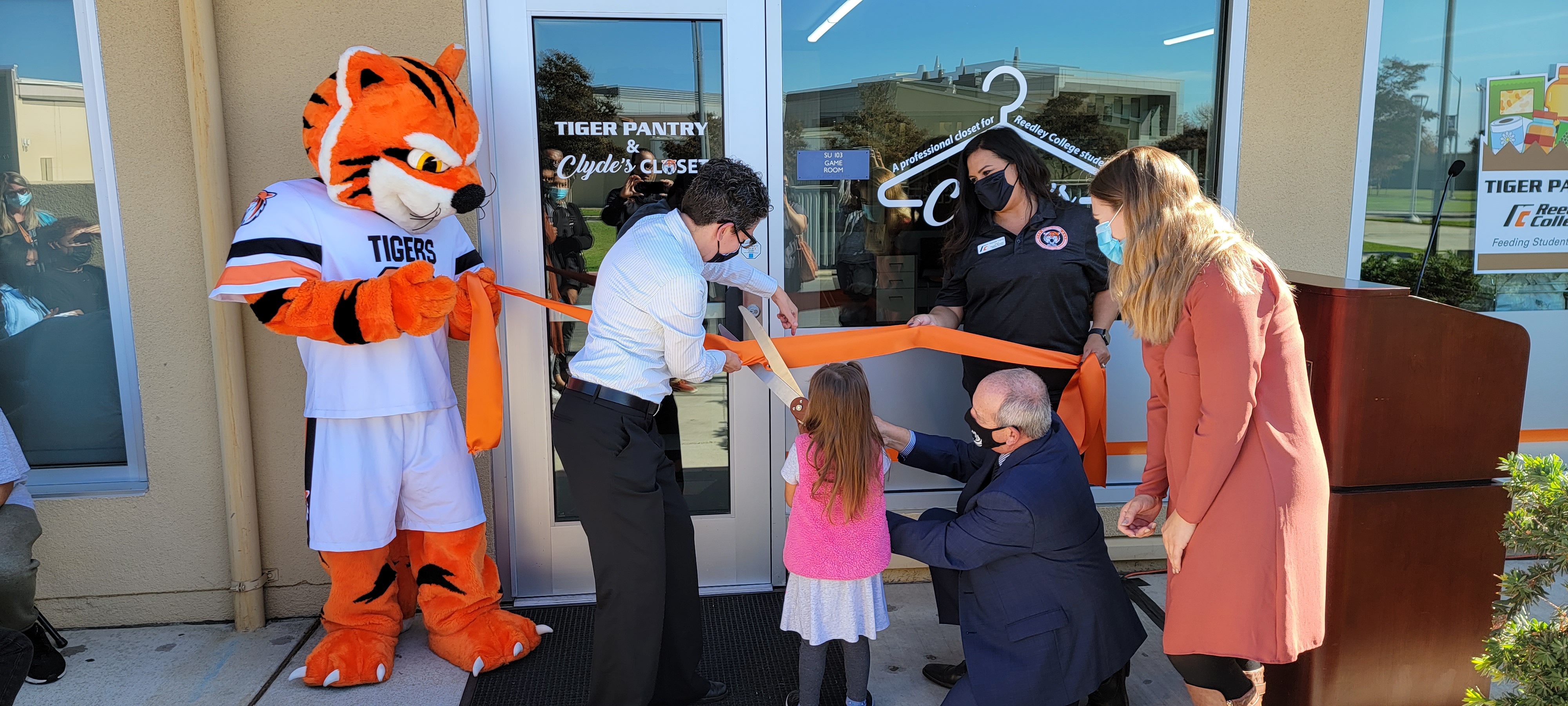 President Buckley and Clyde cutting ribbon on Tiger Pantry