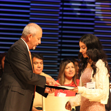 Dr. Buckley giving student their scholarship award on stage.