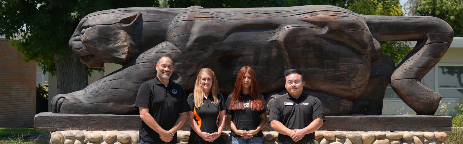 Marketing and Communication Team from left to right (George Takata, Director of Marketing & Communications, Leah Unruh, Marketing & Communications Specialist, Sarahi Sanchez Soto, Student Assistant, Kong Chang, Web Content Engineer) in front of Clyde Status on Reedley College Campus