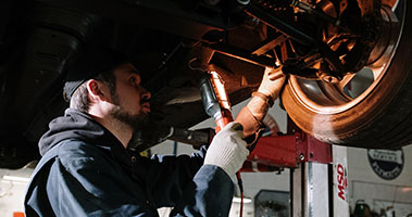 automotive student working under car