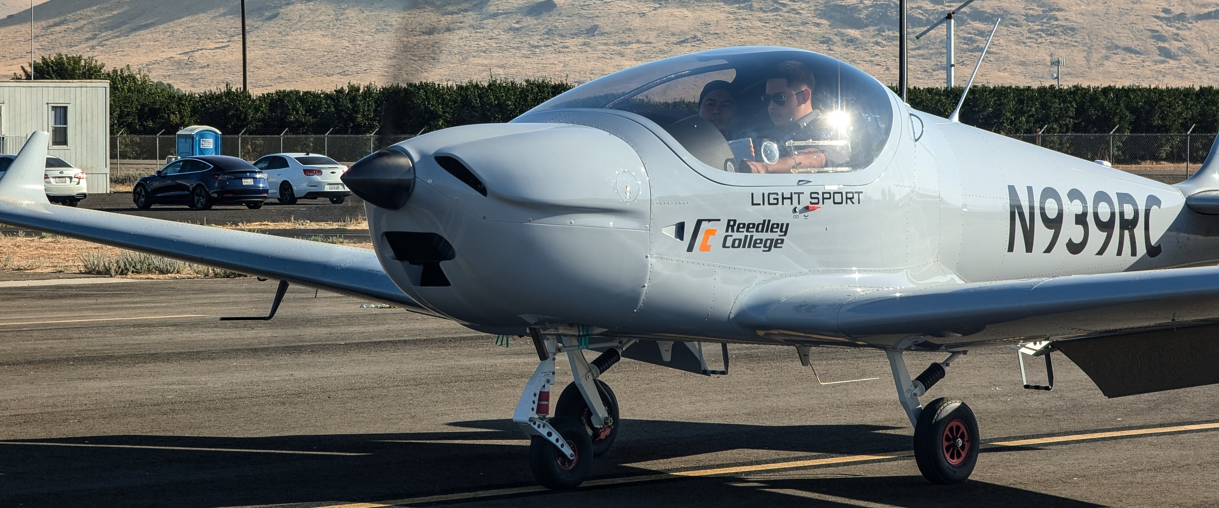 Flight Science Student inside Plane, plane on driveway