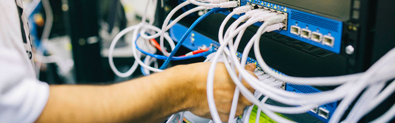 systems admin working with cables