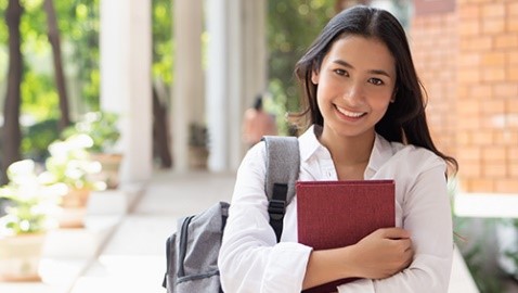 student holding books