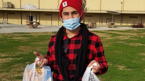 Student holding groceries