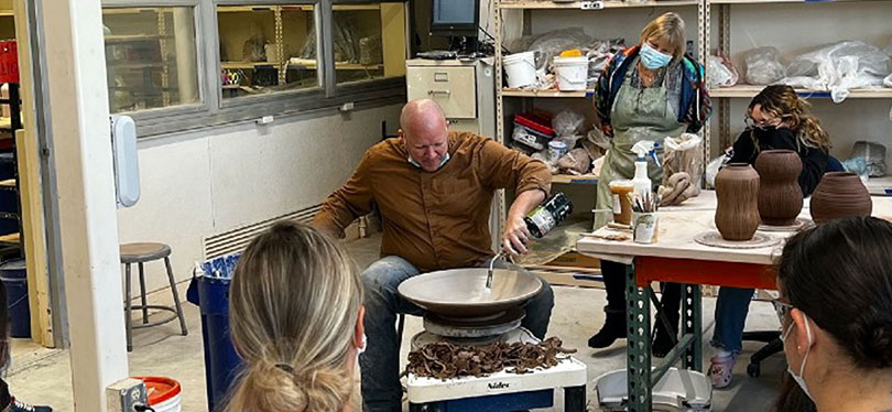 ceramics teacher working with torch in hand