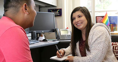 Student sitting with mental health professional.