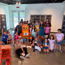 Students with their "paper tiger" at The River Art Gallery inside the McClarty Center for Fine & Performing Arts.